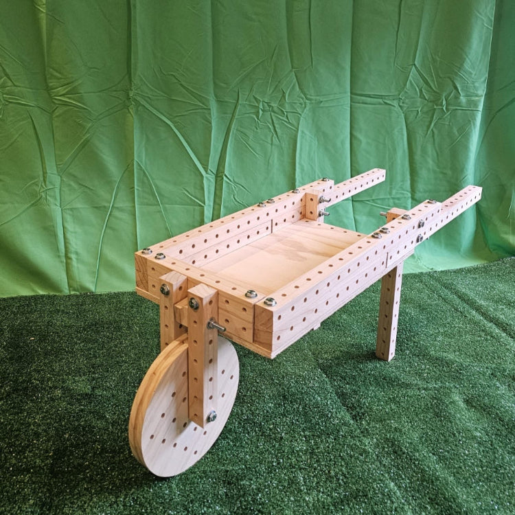 Wooden wheelbarrow-like structure on a green background